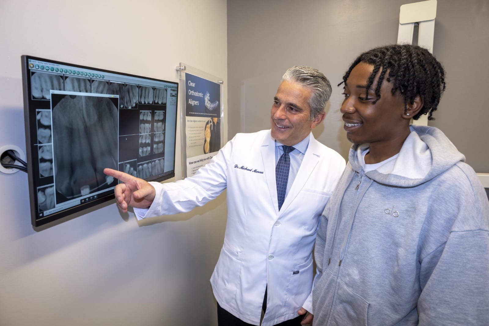 Dr. Marcus showing a patient x-rays on a screen