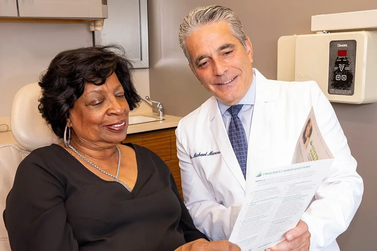 Dr. Marcus showing treatment options to a patient