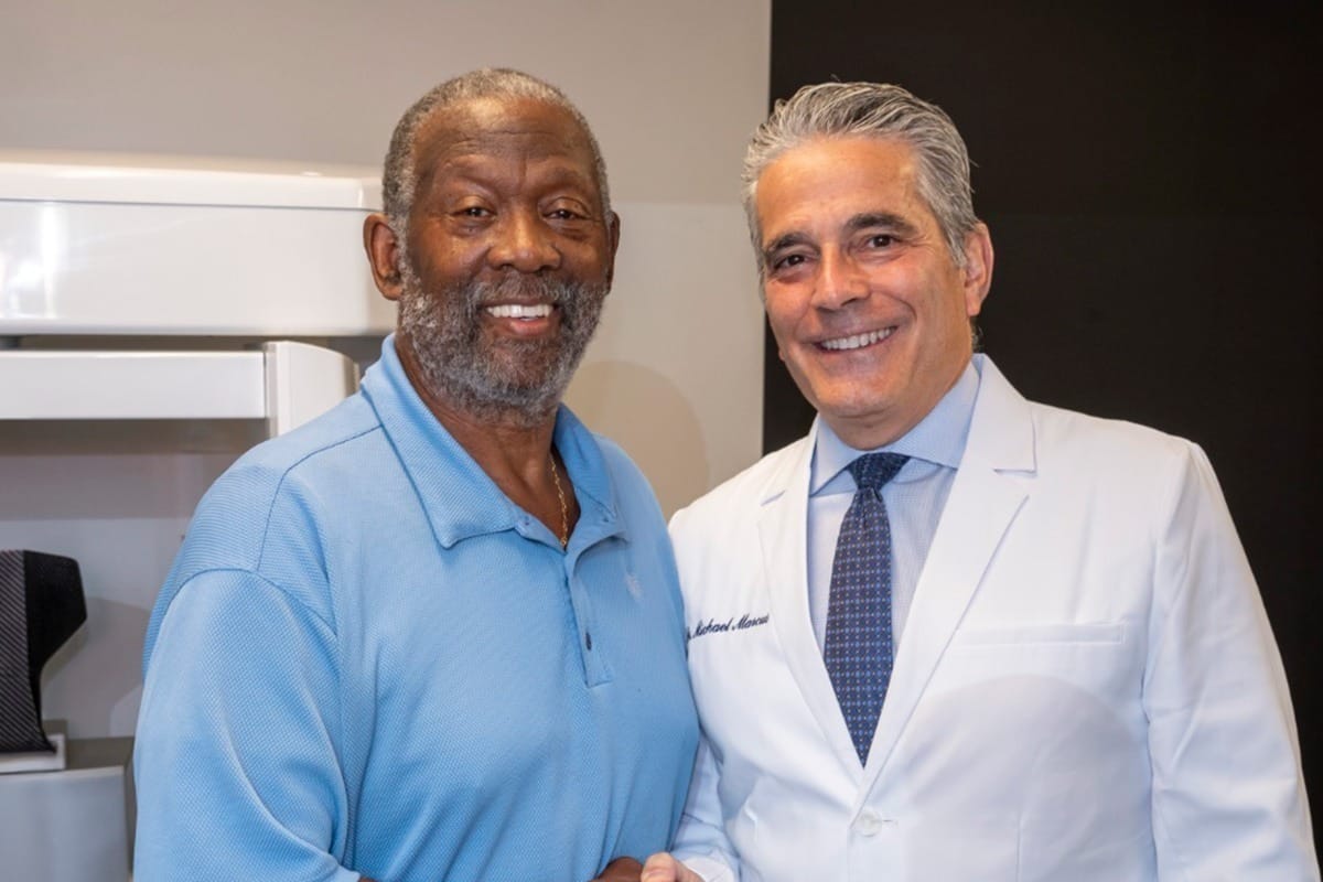 Dr. Marcus shaking a patient's hand