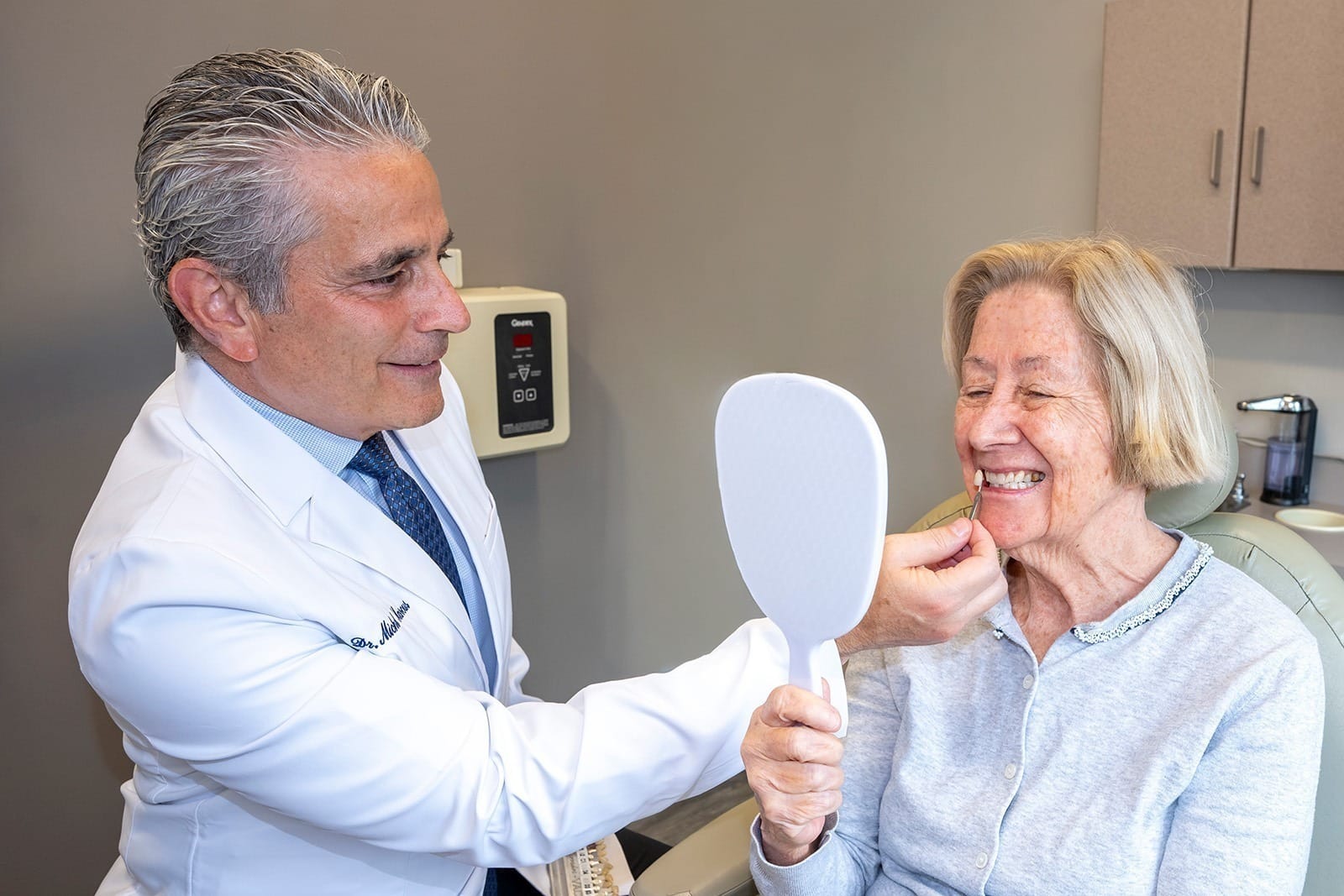 Dr. Marcus shows a patient a single veneer model