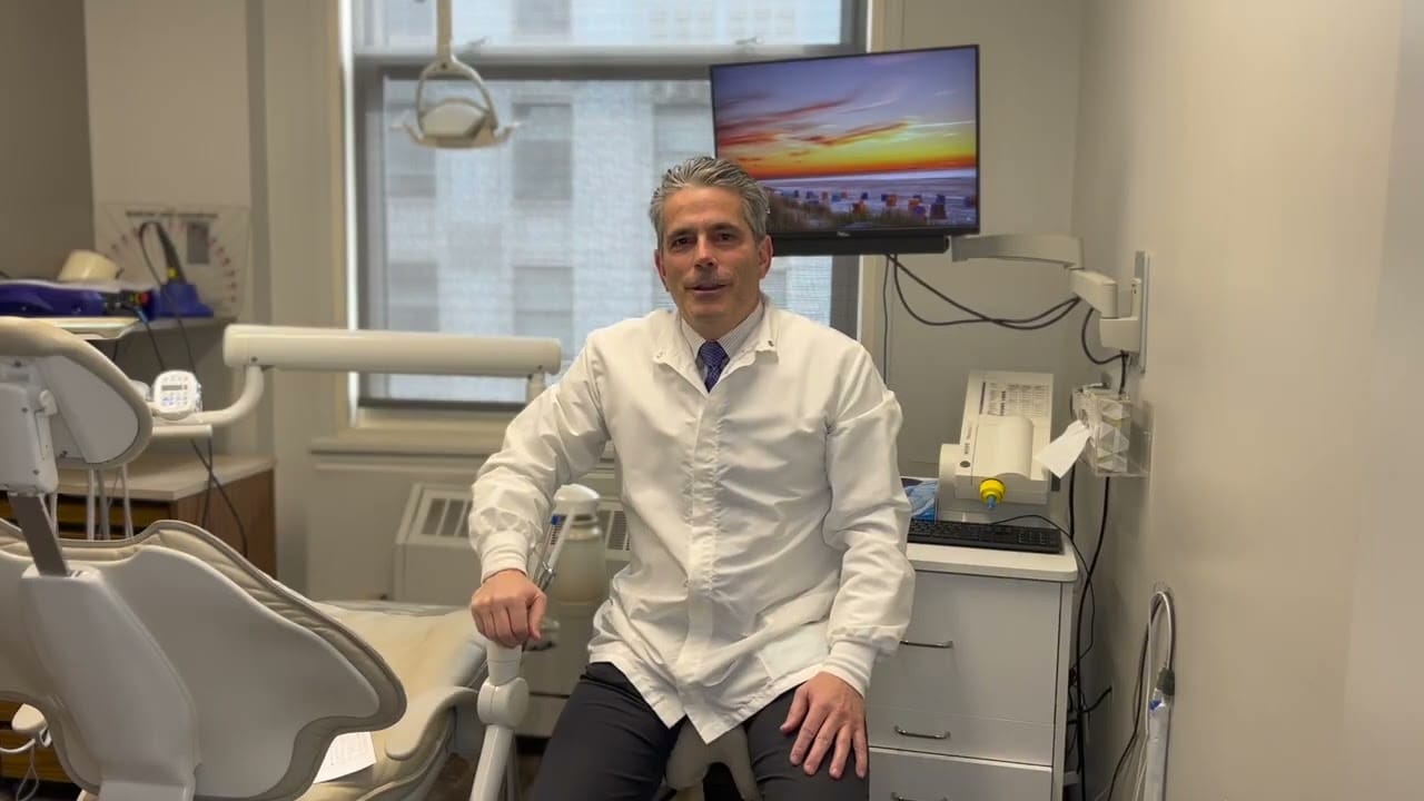 Dr. Michael Marcus sitting in front of high tech general dentistry equipment.